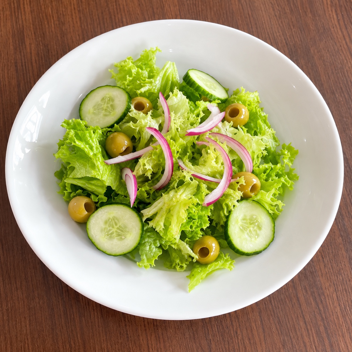 Gruener Salat mit Gurke, gruenen Oliven und Zwiebeln